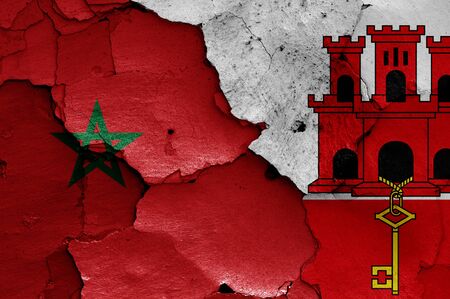 flags of Morocco and Gibraltar painted on cracked wallの写真素材