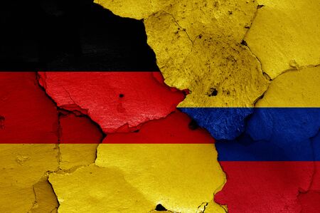 flags of Germany and Colombia painted on cracked wallの写真素材