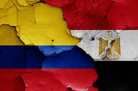 flags of Colombia and Egypt painted on cracked wallの写真素材