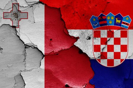 flags of Malta and Croatia painted on cracked wallの写真素材