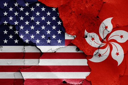 flags of USA and Hong Kong painted on cracked wallの写真素材
