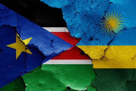 flags of South Sudan and Rwanda painted on cracked wallの写真素材