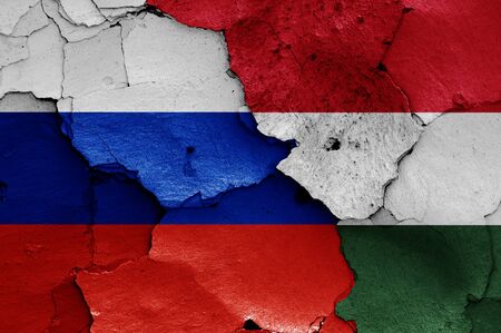 flags of Russia and Hungary painted on cracked wallの写真素材