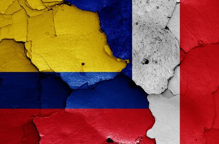 flags of Colombia and France painted on cracked wallの写真素材