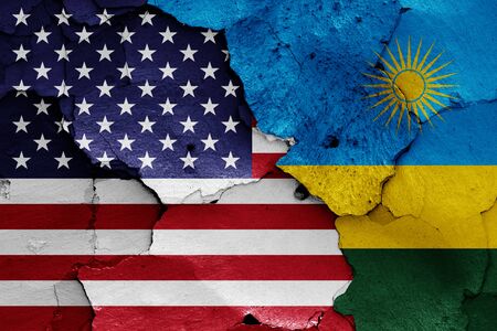 flags of USA and Rwanda painted on cracked wallの写真素材