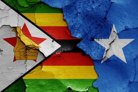 flags of Zimbabwe and Somalia painted on cracked wallの写真素材