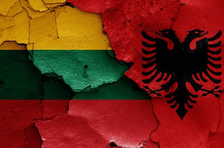 flags of Lithuania and Albania painted on cracked wallの写真素材