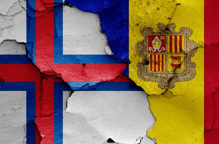 flags of Faroe Islands and Andorra painted on cracked wallの写真素材