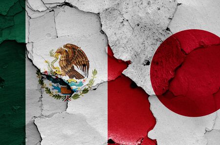 flags of Mexico and Japan painted on cracked wallの写真素材