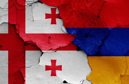 flags of Georgia and Armenia painted on cracked wallの写真素材