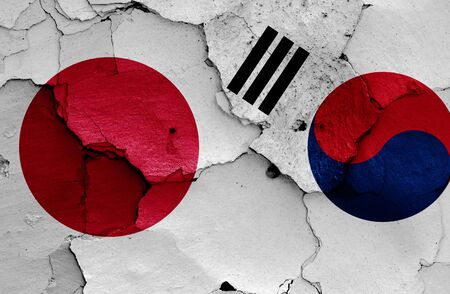 flags of Japan and South Korea painted on cracked wallの写真素材