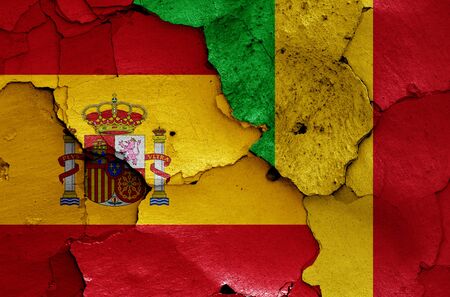 flags of Spain and Mali painted on cracked wallの写真素材