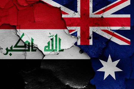 flags of Iraq and Australia painted on cracked wallの写真素材
