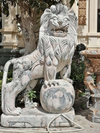 Vietnam, Da Nang - February 26, 2020: pink marble lion sculpture in the area of the Marble Mountainsのeditorial素材