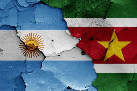 flags of Argentina and Suriname painted on cracked wallの写真素材