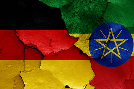 flags of Germany and Ethiopia painted on cracked wallの写真素材