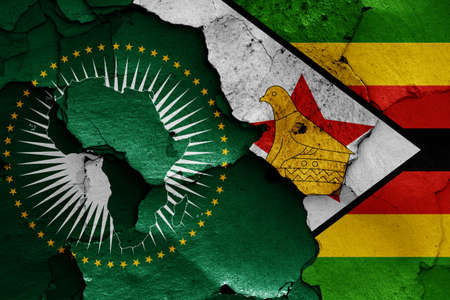 flags of African Union and Zimbabwe painted on cracked wallの写真素材