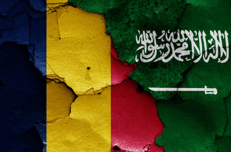 flags of Chad and Saudi Arabia painted on cracked wallの写真素材