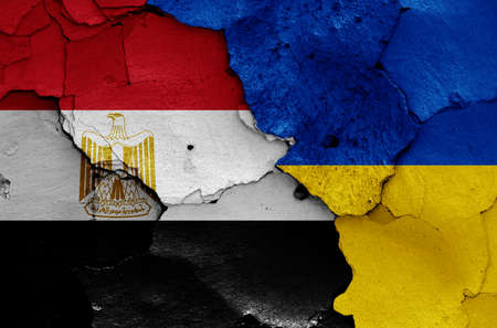 flags of Egypt and Ukraine painted on cracked wallの写真素材