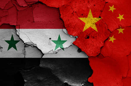 flags of Syria and China painted on cracked wallの写真素材
