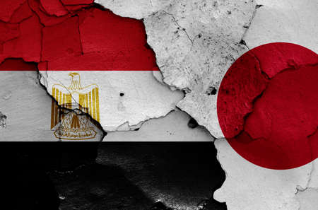 flags of Egypt and Japan painted on cracked wallの写真素材