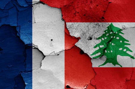 flags of France and Lebanon painted on cracked wallの写真素材