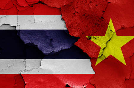 flags of Thailand and Vietnam painted on cracked wallの写真素材