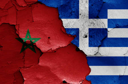 flags of Morocco and Greece painted on cracked wallの写真素材