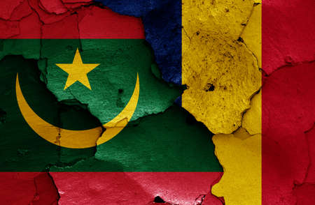 flags of Mauritania and Chad painted on cracked wallの写真素材