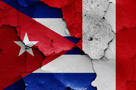 flags of Cuba and Peru painted on cracked wallの写真素材