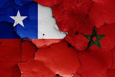 flags of Chile and Morocco painted on cracked wallの写真素材