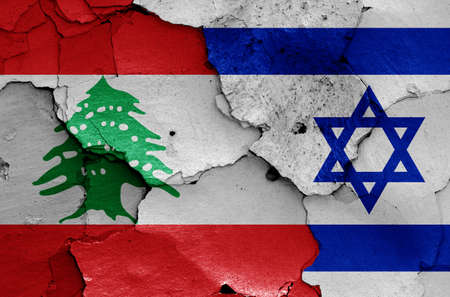 flags of Lebanon and Israel painted on cracked wallの写真素材