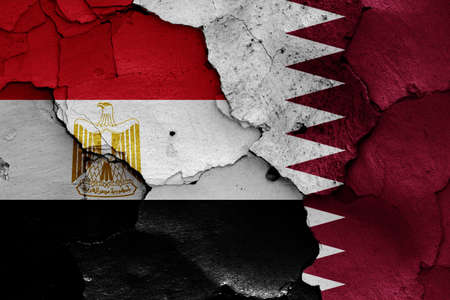 flags of Egypt and Qatar painted on cracked wallの写真素材