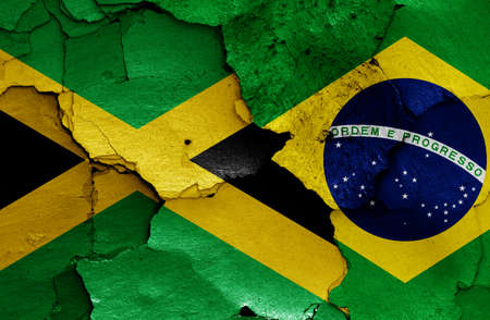 flags of Jamaica and Brazil painted on cracked wallの写真素材