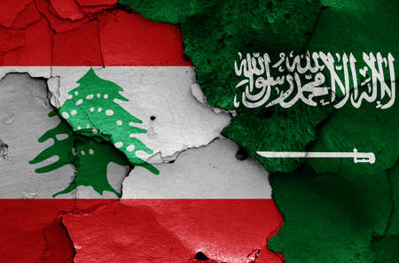 flags of Lebanon and Saudi Arabia painted on cracked wallの写真素材