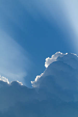 sunlight shining through layers of cloudsの写真素材