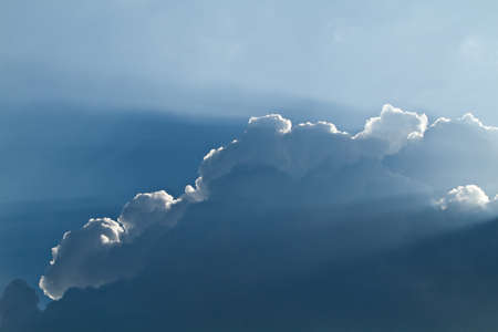 sunlight shining through layers of clouds