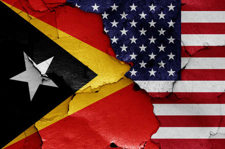flags of East Timor and USA painted on cracked wallの写真素材