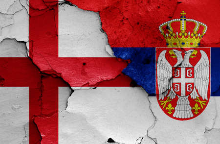 flags of England and Serbia painted on cracked wallの写真素材