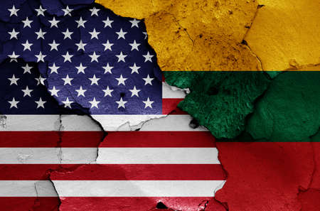 flags of USA and Lithuania painted on cracked wallの写真素材