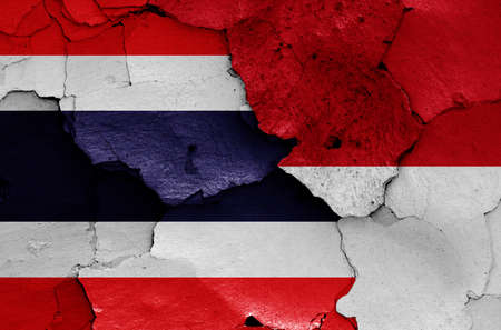 flags of Thailand and Indonesia painted on cracked wallの写真素材