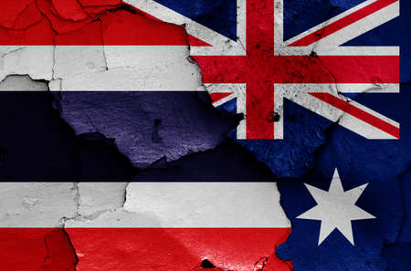 flags of Thailand and Australia painted on cracked wallの写真素材