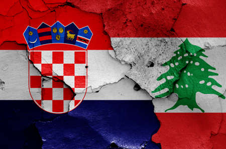 flags of Croatia and Lebanon painted on cracked wallの写真素材