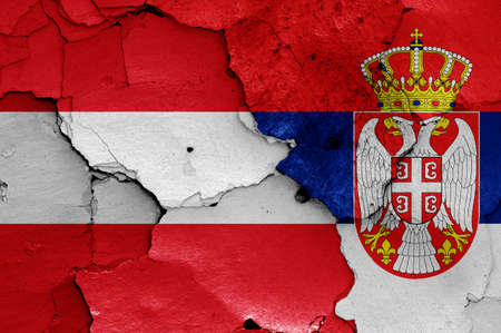 flags of Austria and Serbia painted on cracked wallの写真素材