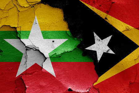 flags of Myanmar and East Timor painted on cracked wallの写真素材
