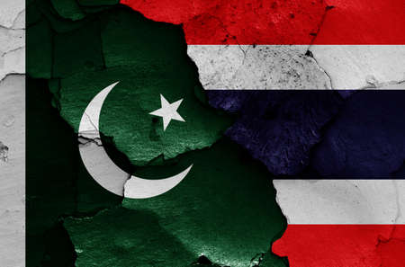 flags of Pakistan and Thailand painted on cracked wallの写真素材