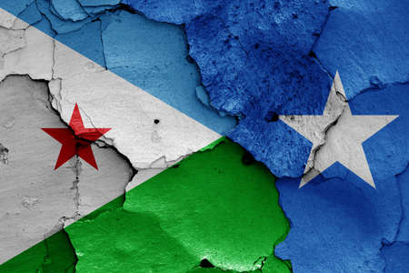 flags of Djibouti and Somalia painted on cracked wallの写真素材