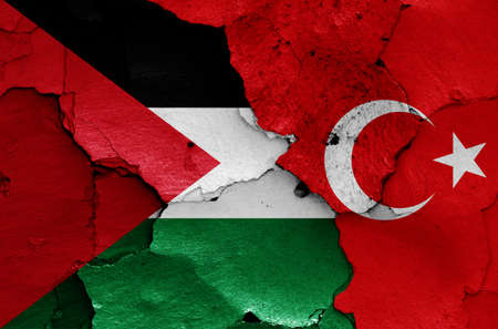 flags of Palestine and Turkey painted on cracked wallの写真素材