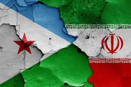 flags of Djibouti and Iran painted on cracked wallの写真素材