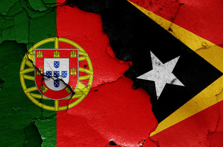 flags of Portugal and East Timor painted on cracked wallの写真素材
